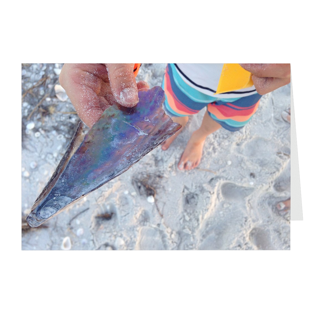 Meghan Nathanson Artistry color photo of child's hands holding a shell on the beach on folded greeting card