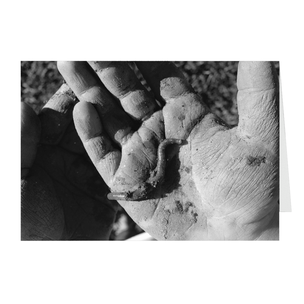 Meghan Nathanson Artistry black and white photo of a child's hands holding a worm on folded greeting card
