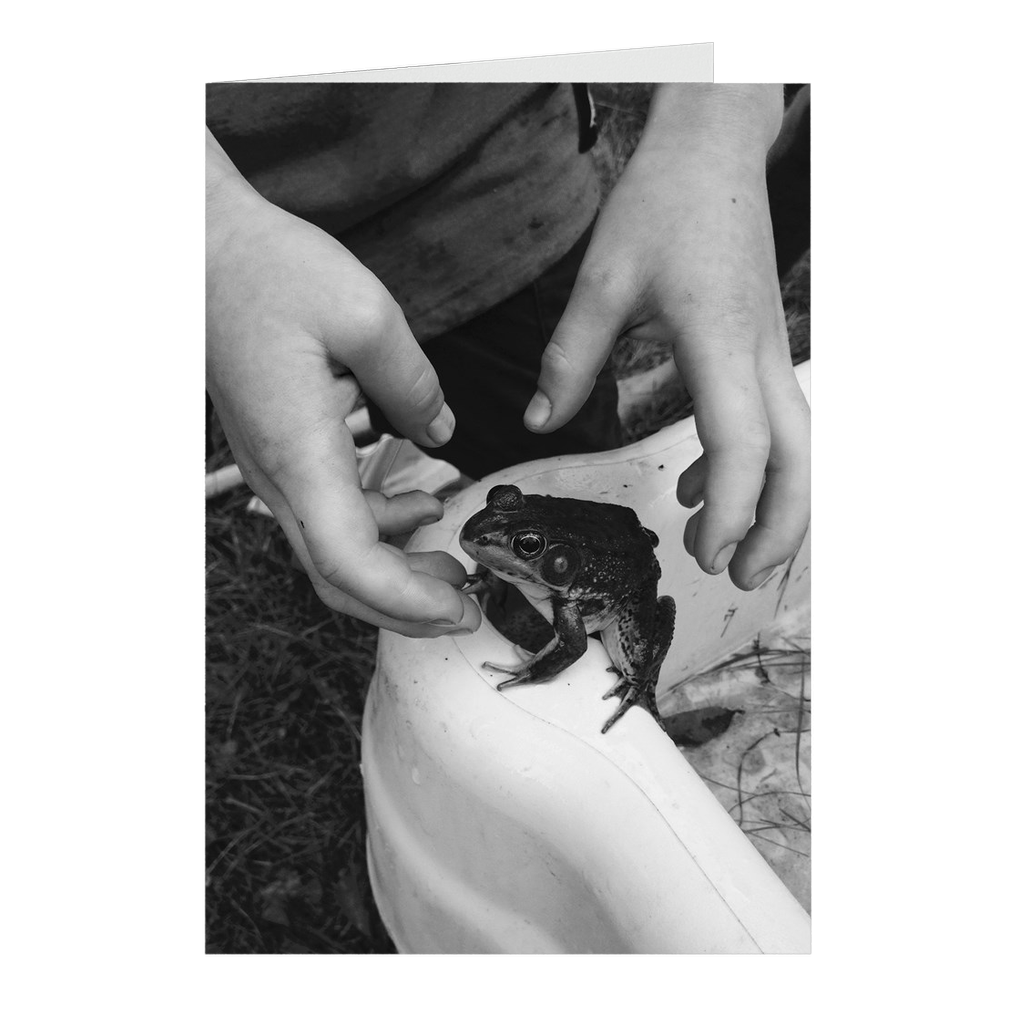 Meghan Nathanson Artistry black and white photo of child and frog on folded greeting card